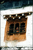 Children peeking down from a window. :: Kagbeni, Nepal